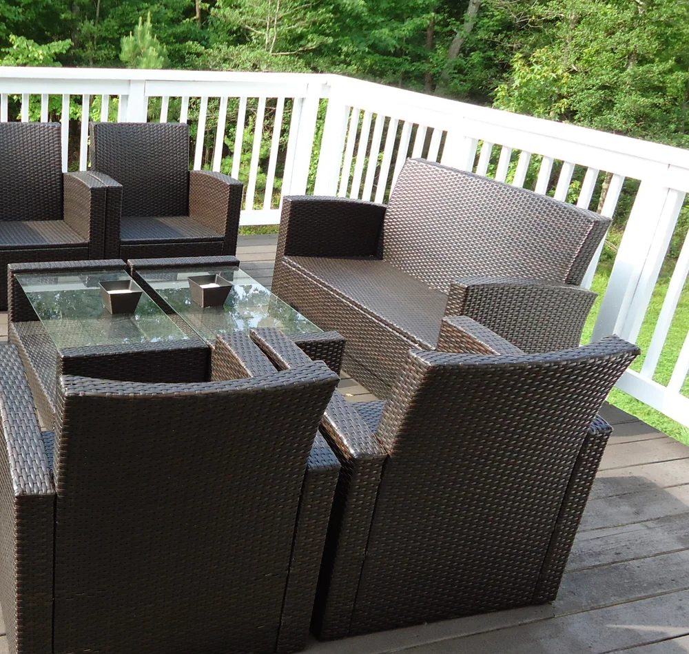Composite deck corner with white railing and outdoor lounge furniture